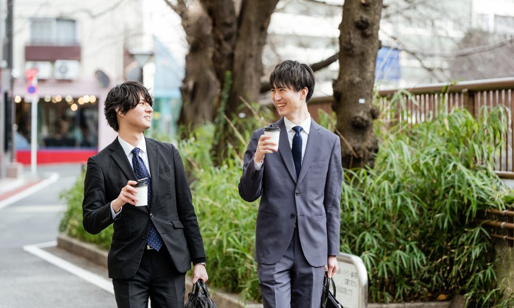 Japanese guys flirt, two men wearing suits, talking
