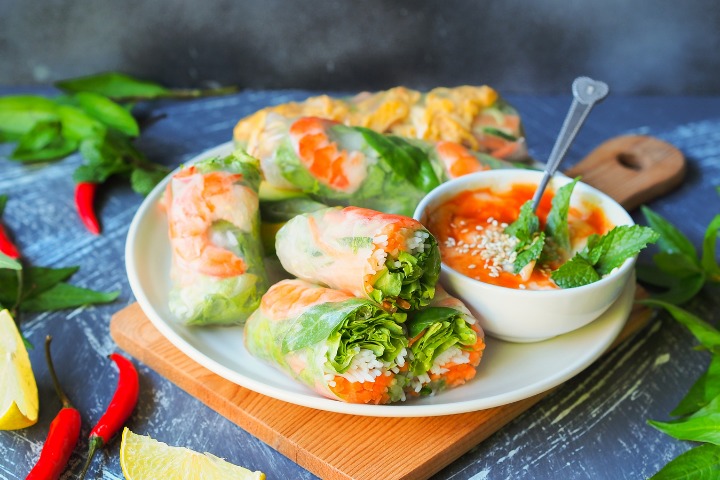 delicious vietnamese spring rolls on a plate, displayed beautifully from a vietnamese restaurant or home setting