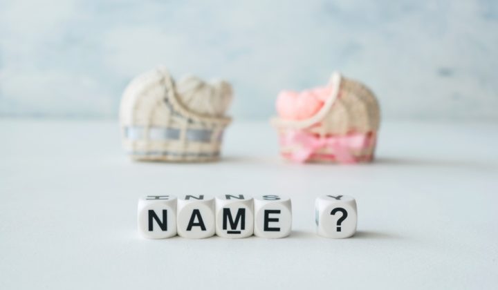 two mini bassinets in pink and blue with the word name and a question mark in front