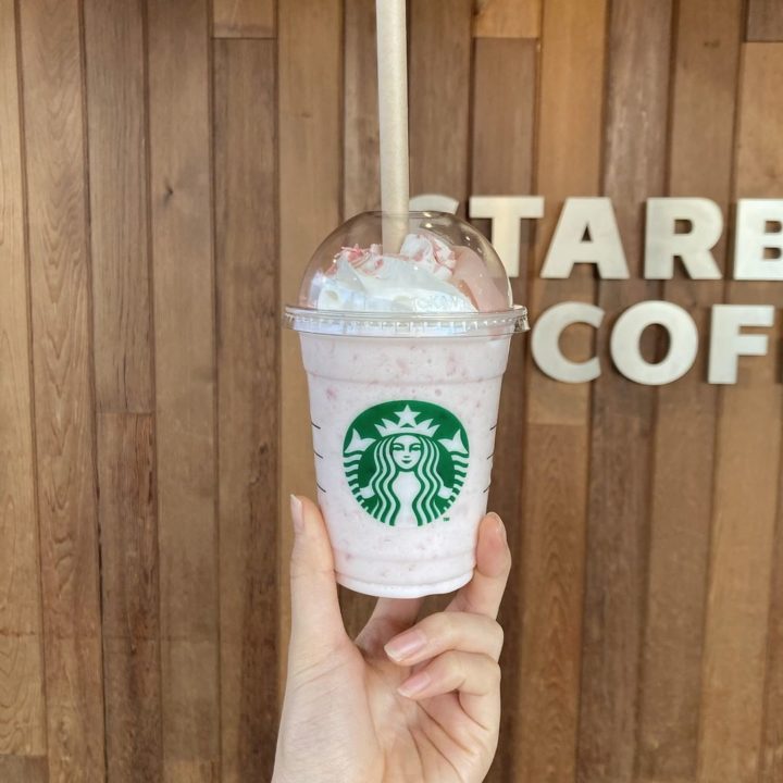 photo of hand holding up Starbucks spring season limited edition sakura drink