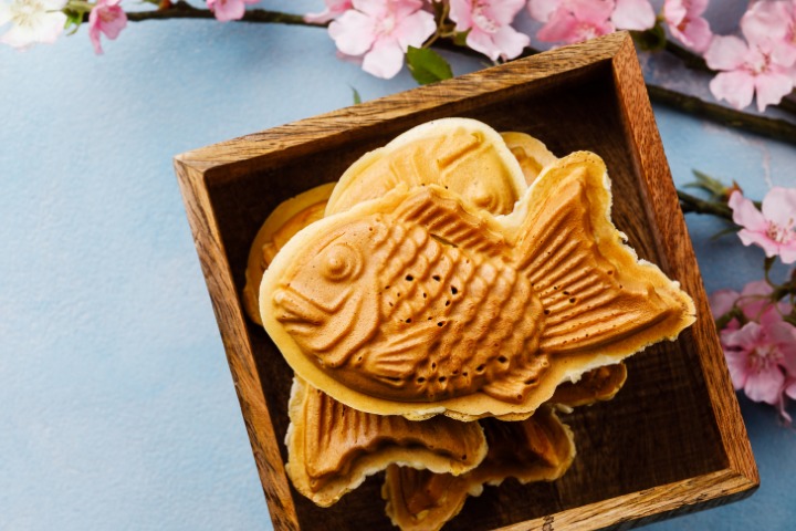 Taiyaki in a squared wood box with a branch of sakura 
