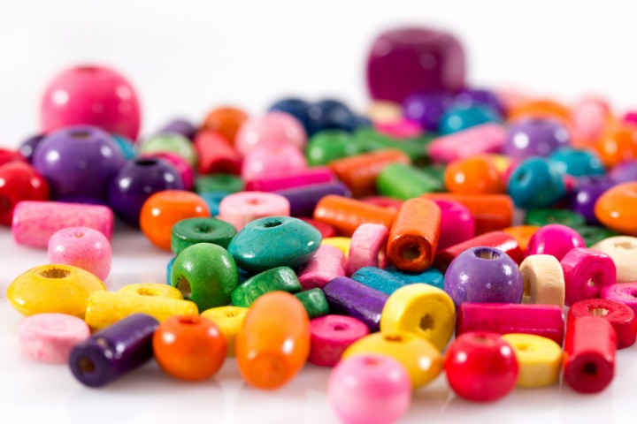 a photo of multi-coloured beads on a white background