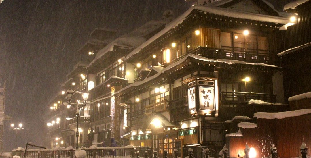 a photo of ginzan onsen main street at night in the snow