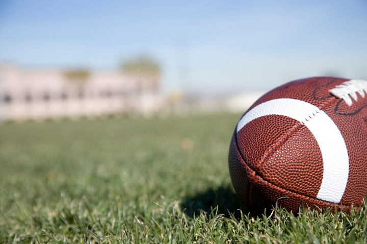 a photo of an american football on a pitch