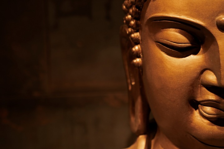 a photo of a fat buddha with big earlobes