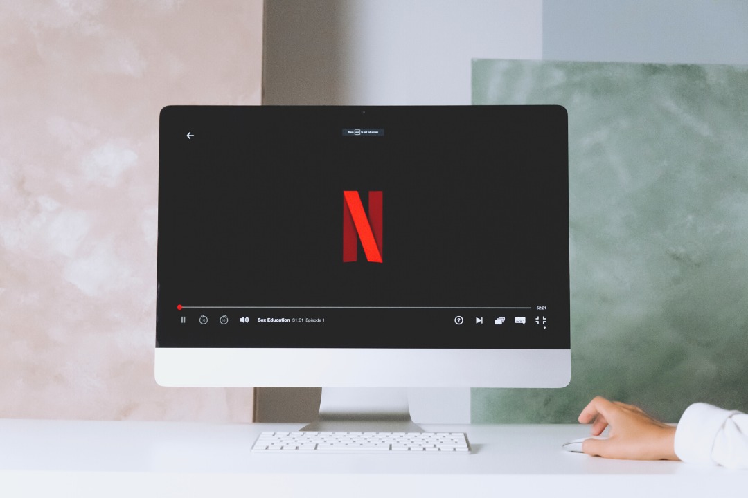 a photo of a computer showing the netflix logo