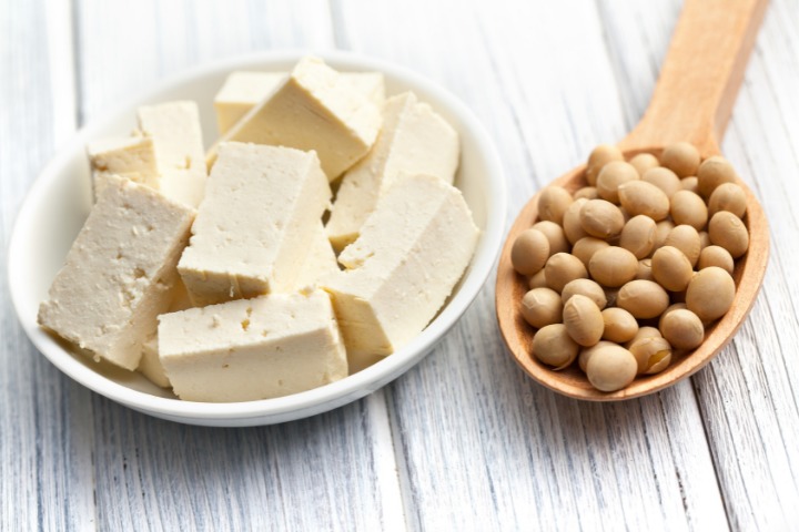 a photo of momen tofu next to a spoon of soy beans