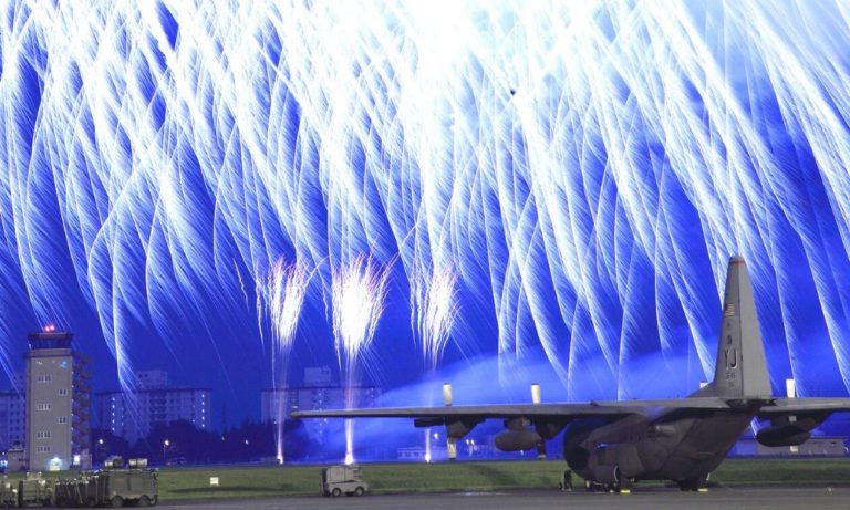 a photo of a frieworks show at yokota airbase witha jet