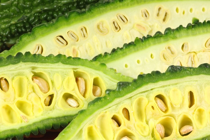 a photo of a goya bitter melon cut open