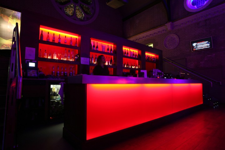 a photo of a DJ bar where the bar is lit up in red