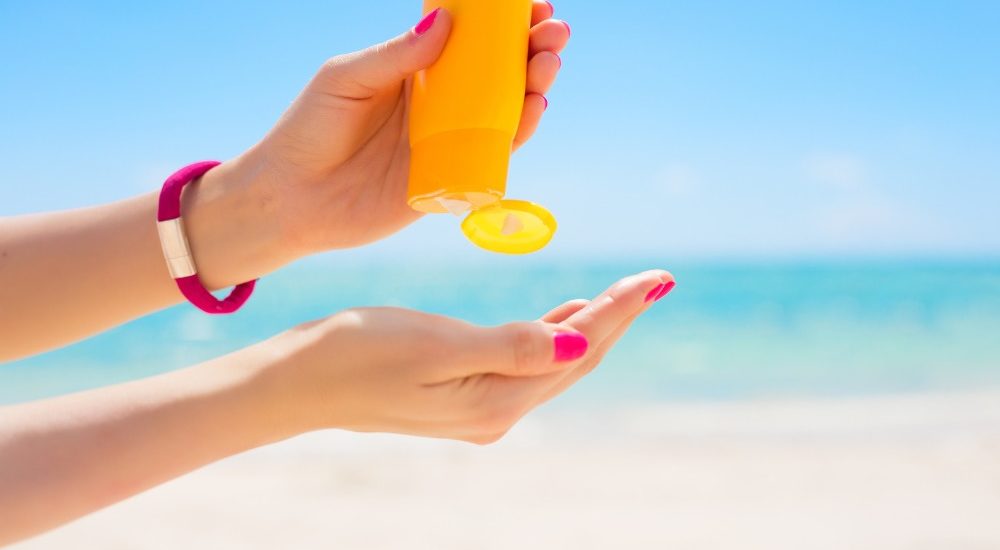 a photo of a pair of hands with one squeezing sunscreen onto the other hand