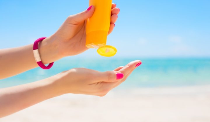 a photo of a pair of hands with one squeezing sunscreen onto the other hand