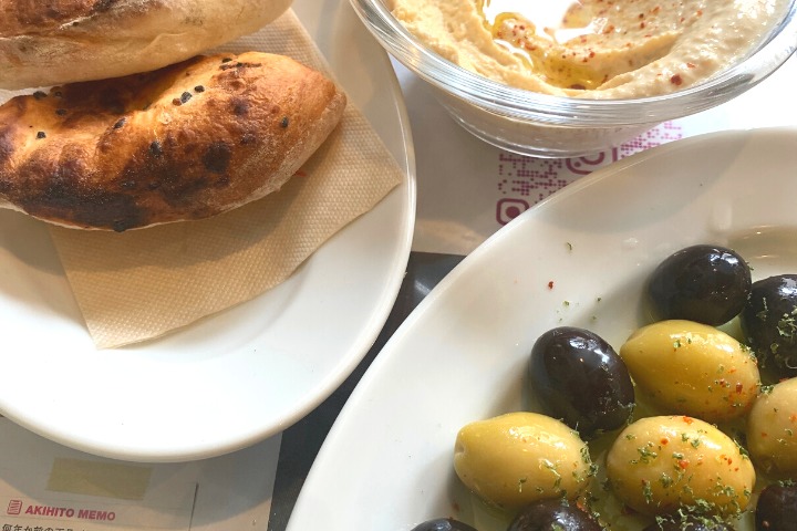 a photo of olives hummus and Turkish bread at a Turkish restaurant in Tokyo