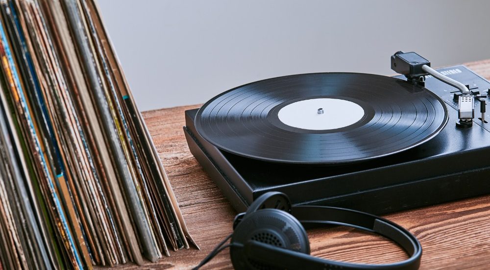 a photo of a record player and several vinyl records