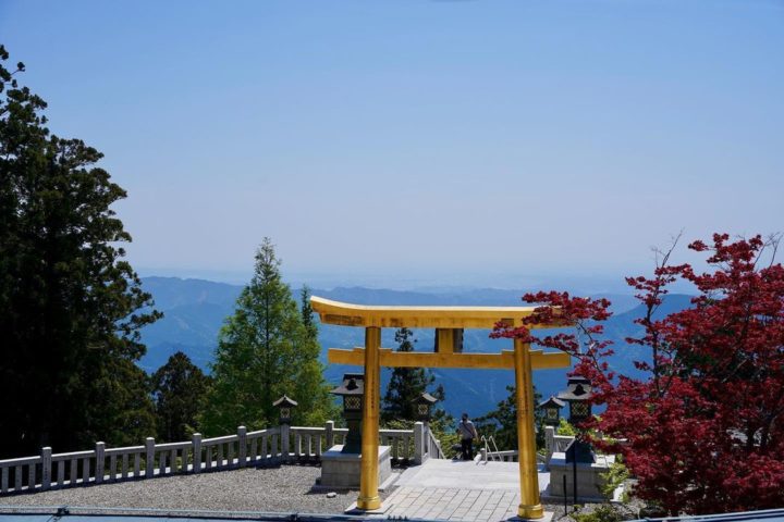 a photo of a torii gate looking out over mountains at akiba hongu shrine