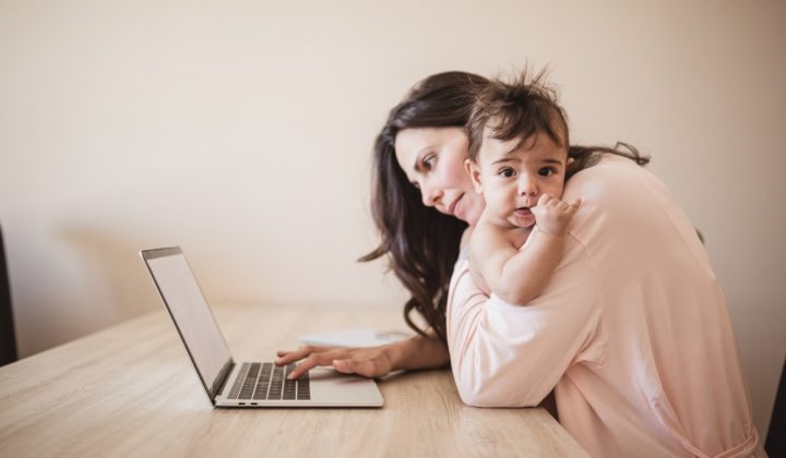 single working woman using laptop with child