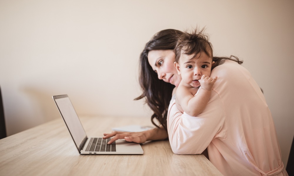 single working woman using laptop with child