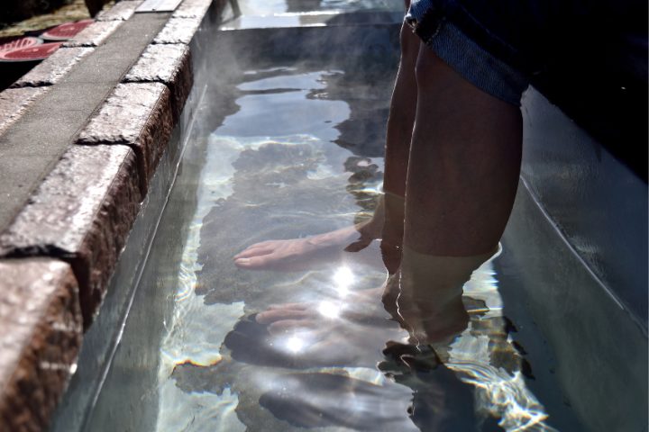 person's feet in Ashiyu or foot onsen outside