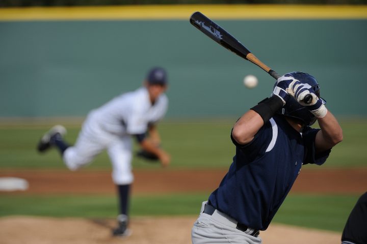 Men playing catch in Japanese baseball: one is mid-throw while the other is positioned to catch the ball.
