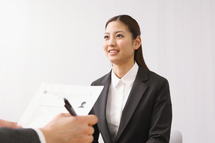 Woman in a black suit attending a job interview