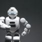 photo of a white robot in front of a black background
