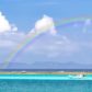 a photo of a rainbow over the okinawan sea during tsuyu